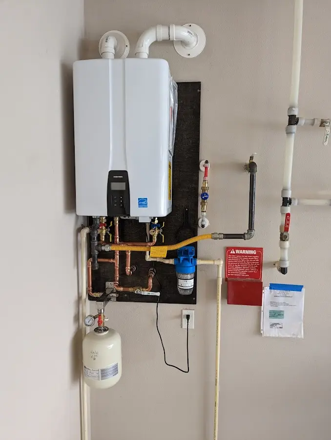 Professional plumber installing copper piping in a Watkinsville home